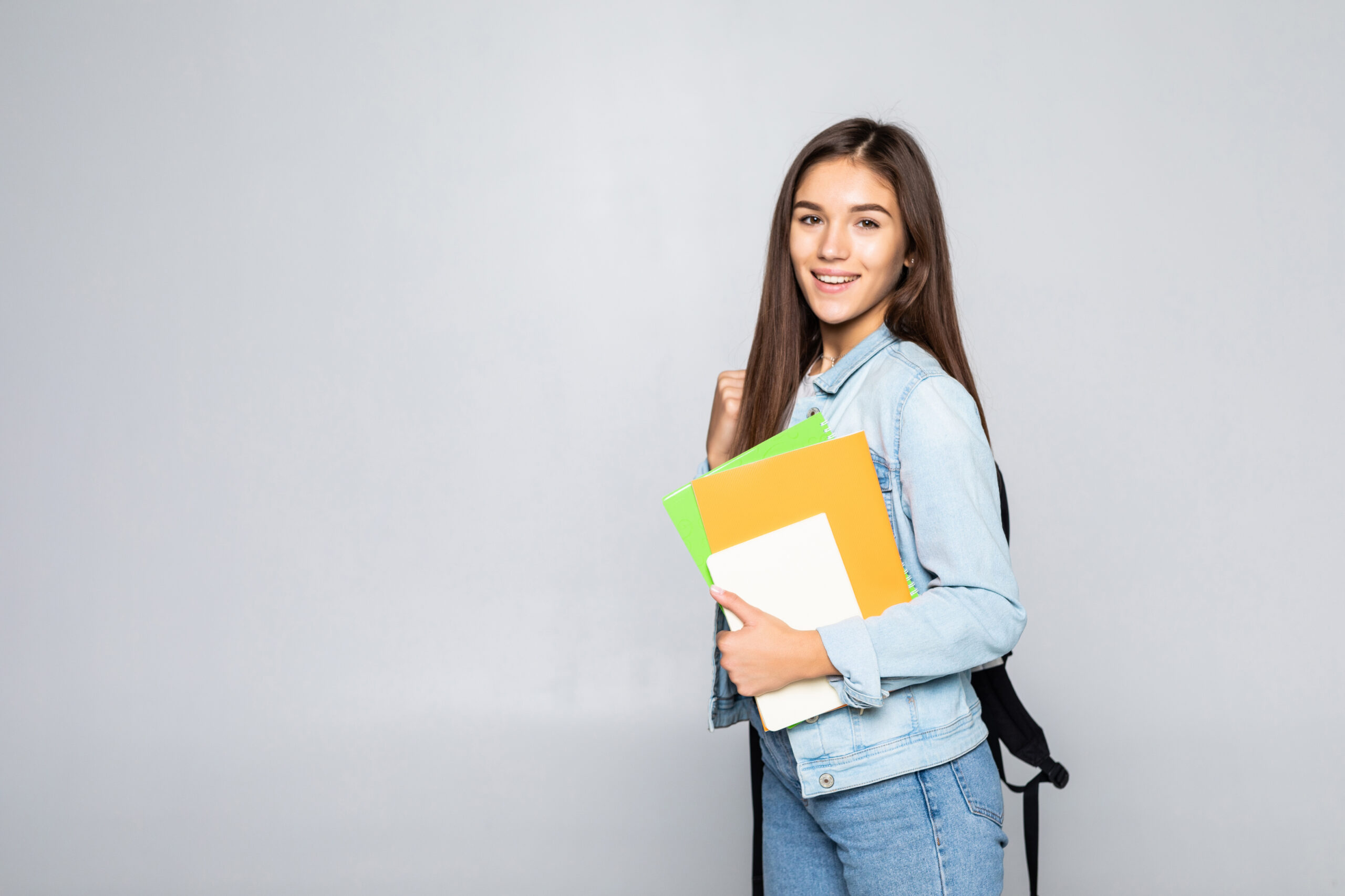 Portrait of attractive cute young student girl isolated on white background